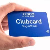 Tesco Clubcard in hand